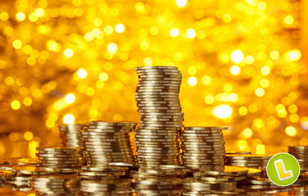 Coins stack on golden bokeh background